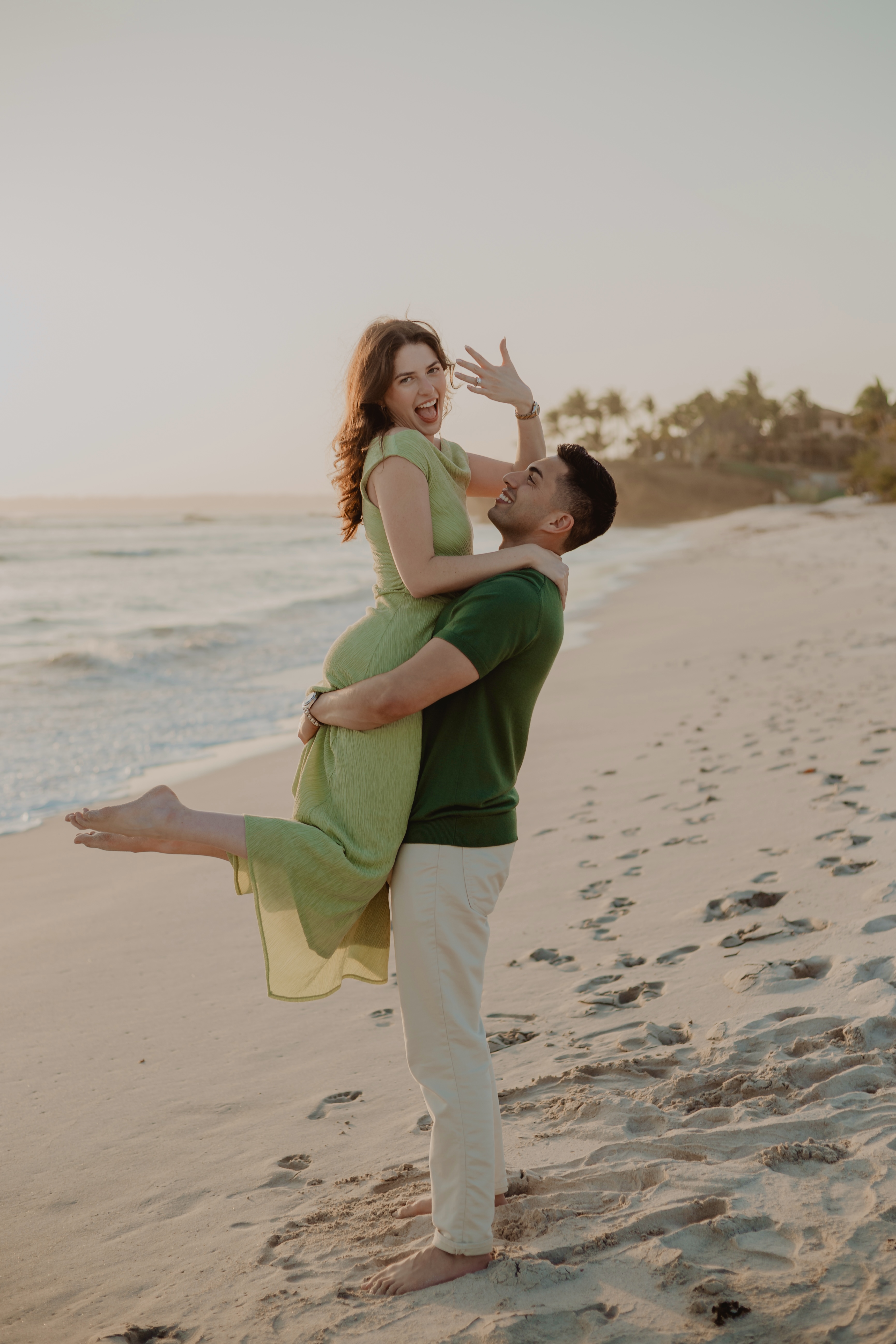 Taylor and Joey embracing on the beach at sunset